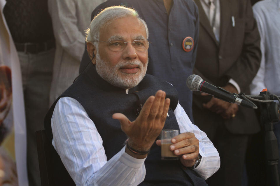 India's opposition Bharatiya Janata Party (BJP)'s prime ministerial candidate Narendra Modi, interacts with people as he launches the 'Discussion over tea' campaign in Ahmadabad, India, Wednesday, Feb. 12, 2014. (AP Photo/Ajit Solanki)