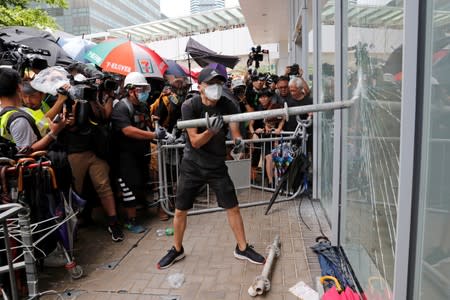 Protesters try to break into the Legislative Council building where riot police are seen, during the anniversary of Hong Kong's handover to China in Hong Kong