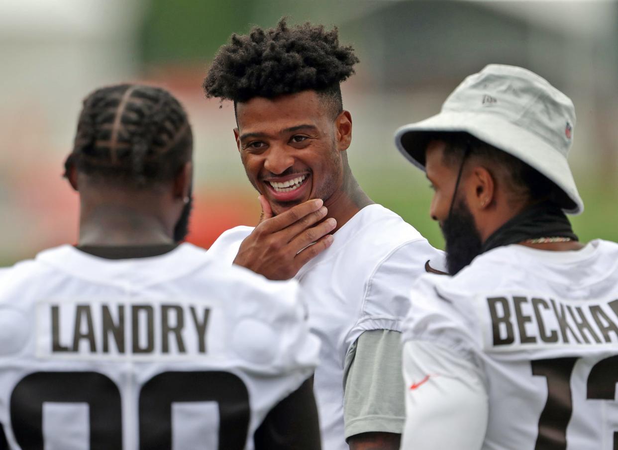 Cleveland Browns wide receiver Rashard Higgins, facing, chats with teammates Jarvis Landry, left, and Odell Beckham Jr. during NFL football training camp, Thursday, July 29, 2021, in Berea, Ohio.