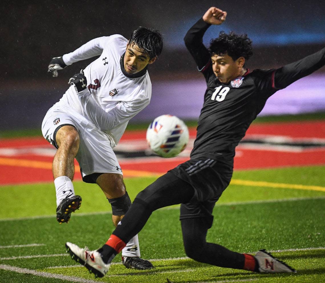 McLane’s Oscar Bolanos, right, tries to get in front of a kick from Chavez’s Aaron Mendez during their Central Section Division III boys soccer championship game at McLane Stadium on Friday, Feb. 24, 2023.