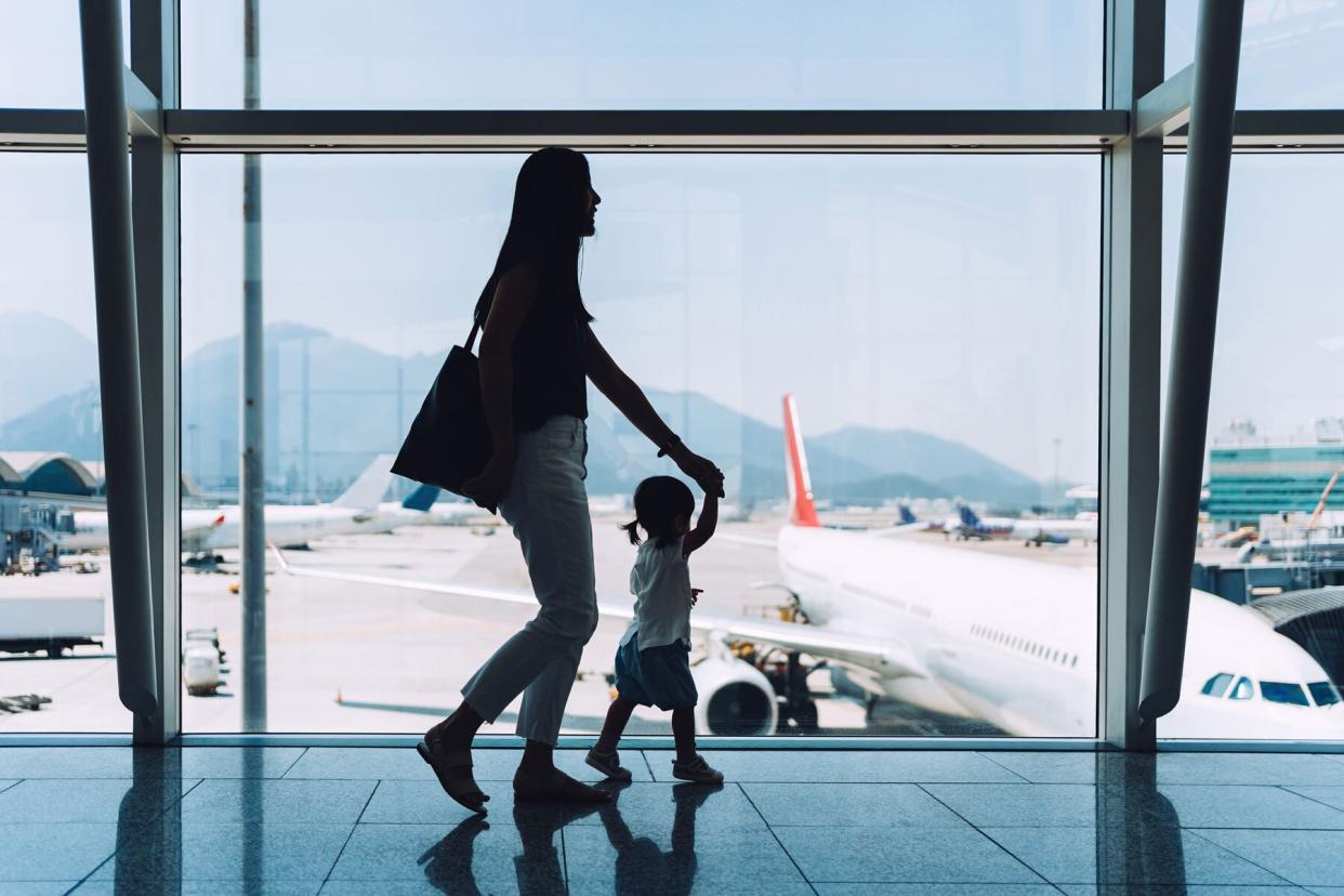 Woman and child walking through airport