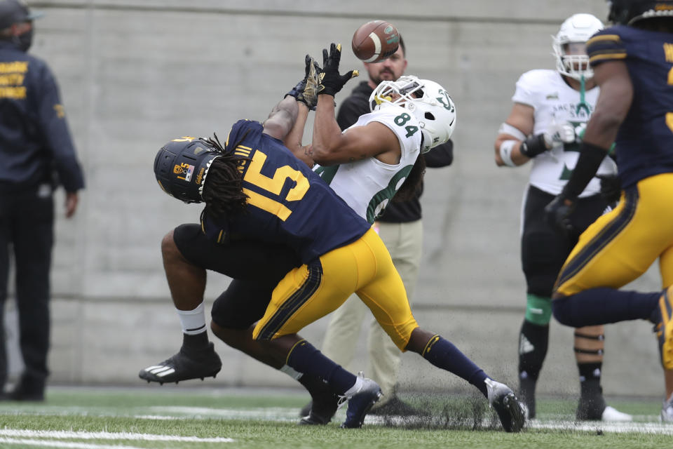 Sacramento State wide receiver Pierre Williams (84) catches a pass over California cornerback Lu-Magia Hearns during the first half of an NCAA college football game on Saturday, Sept. 18, 2021, in Berkeley, Calif. (AP Photo/Jed Jacobsohn)