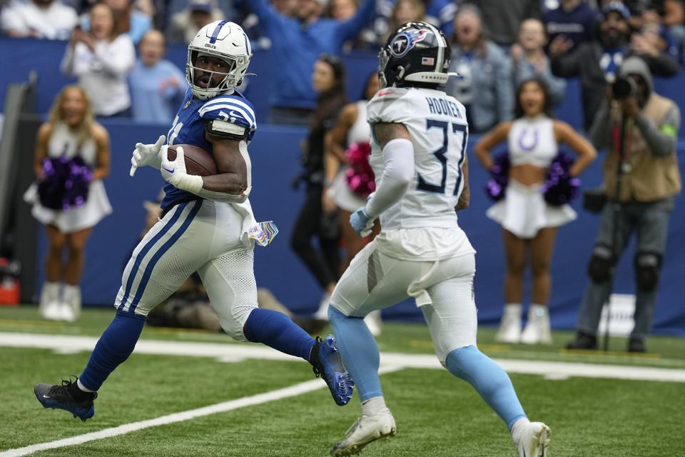 Indianapolis Colts running back Zack Moss, left, runs for a 56-yard touchdown past Tennessee Titans safety <span class="caas-xray-inline-tooltip"><span class="caas-xray-inline caas-xray-entity caas-xray-pill rapid-nonanchor-lt" data-entity-id="Amani_Hooker" data-ylk="cid:Amani_Hooker;pos:4;elmt:wiki;sec:pill-inline-entity;elm:pill-inline-text;itc:1;cat:Athlete;" tabindex="0" aria-haspopup="dialog"><a href="https://search.yahoo.com/search?p=Amani%20Hooker" data-i13n="cid:Amani_Hooker;pos:4;elmt:wiki;sec:pill-inline-entity;elm:pill-inline-text;itc:1;cat:Athlete;" tabindex="-1" data-ylk="slk:Amani Hooker;cid:Amani_Hooker;pos:4;elmt:wiki;sec:pill-inline-entity;elm:pill-inline-text;itc:1;cat:Athlete;" class="link ">Amani Hooker</a></span></span>, right, during the first half of an NFL football game, Sunday, Oct. 8, 2023, in Indianapolis. | Darron Cummings, Associated Press