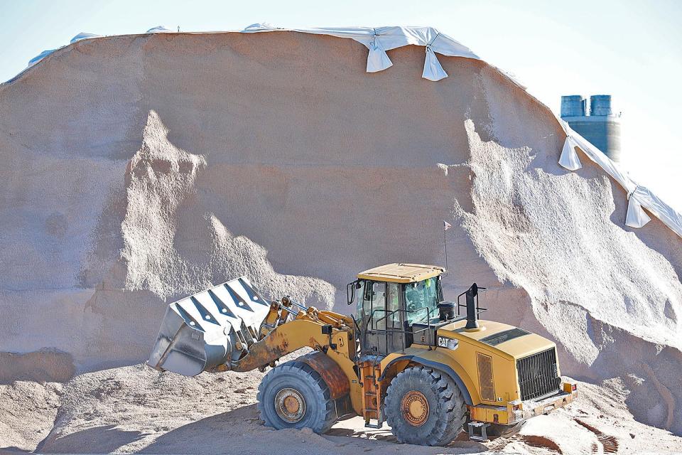 The salt yard at the Quincy Shipyard is busy on Wednesday, Jan. 26, 2022 as trucks line up to haul road salt to towns in preparation for a snow storm this weekend.