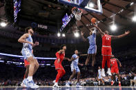 North Carolina forward Leaky Black (1) and Ohio State forward Brice Sensabaugh (10) fight for the ball during the second half of an NCAA college basketball game in the CBS Sports Classic, Saturday, Dec. 17, 2022, in New York. The Tar Heels won 89-84 in overtime. (AP Photo/Julia Nikhinson)