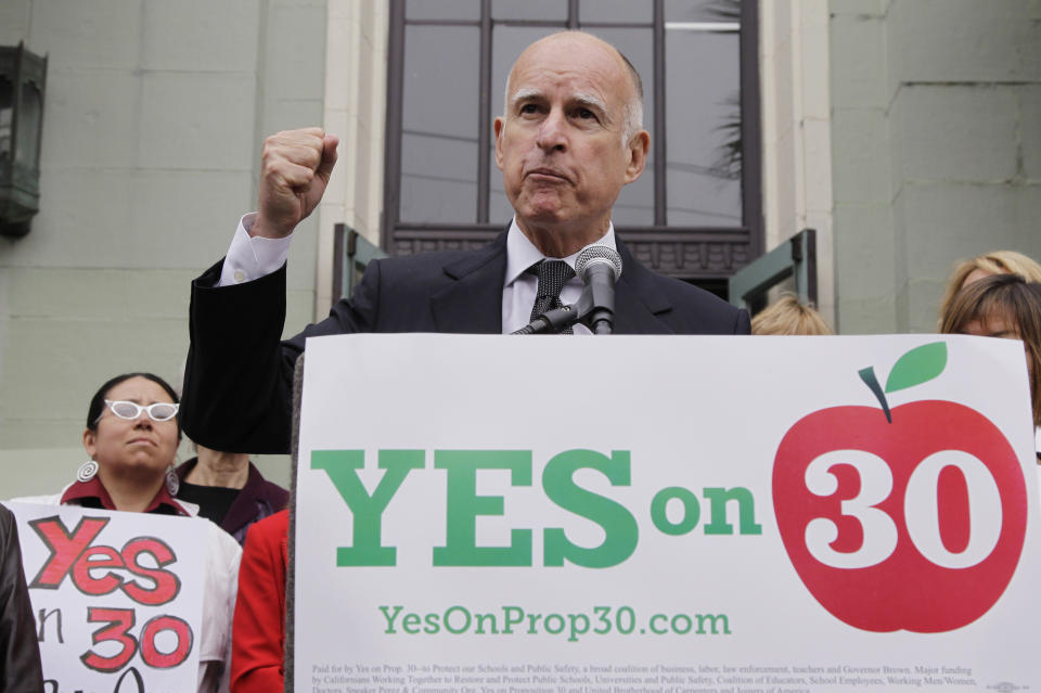 Calif. Gov. Jerry Brown gestures as he campaigns for Proposition 30 at James Lick Middle School in San Francisco, Wednesday, Aug. 22, 2012. As Brown kicked off his campaign for Proposition 30 last week, he sought to emphasize that most of the revenue from the tax increases would come from Californians who are among the wealthiest; an extra $4,500 a year for millionaires, he said. (AP Photo/Paul Sakuma)