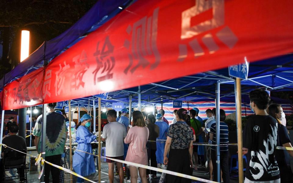 People queue at a Covid-19 testing site in Nanjing, China on 28 July 2021 - Li Bo/Xinhua