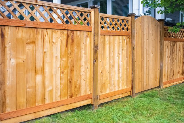 <p>Getty</p> Stock image of a backyard fence