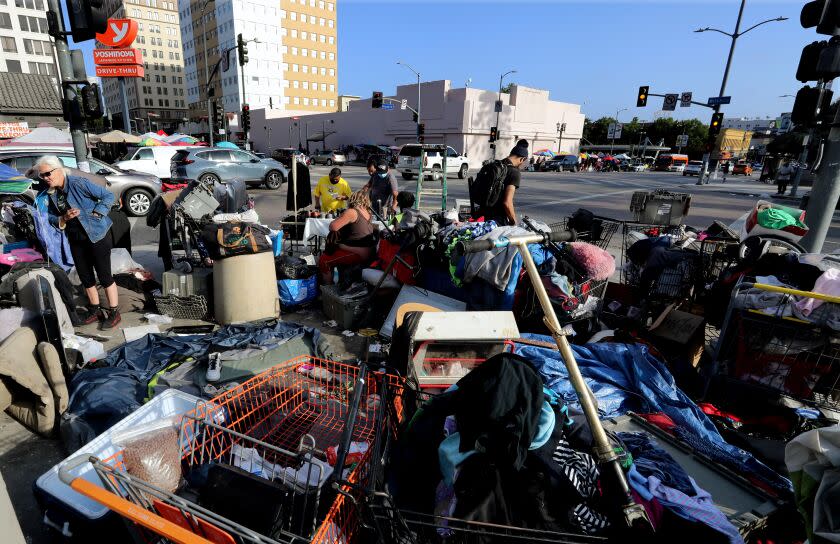 LOS ANGELES, CA - JULY 01:. A homeless encampment encroaches on the sidewalk at the intersection of Wilshire Boulevard and Alvarado Street in MacArthur Park in Los Angeles. (Luis Sinco / Los Angeles Times)