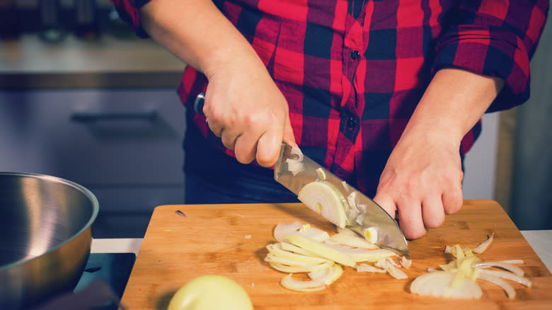 person cutting an onion