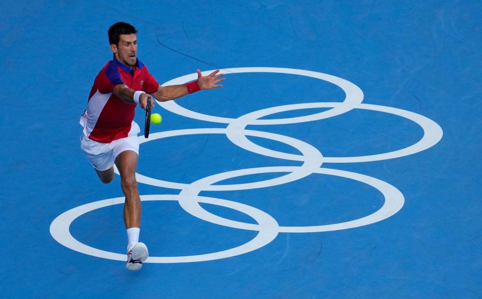 Novak Djokovic reaches for a shot in his loss Pablo Carreno Busta in a bronze medal match.