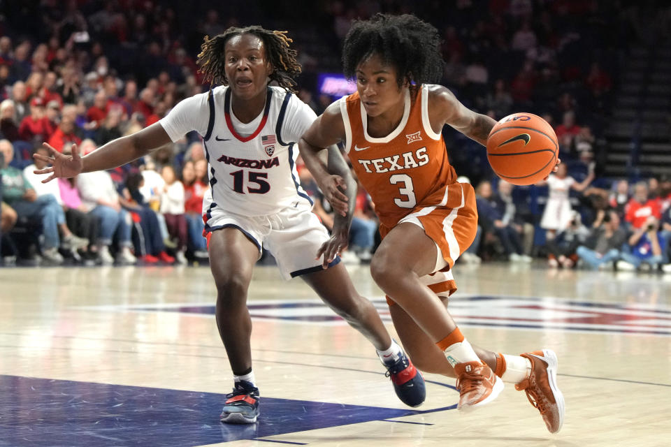 Texas guard Rori Harmon (3) drives on Arizona guard Kailyn Gilbert (15) during the first half of an NCAA college basketball game, Wednesday, Dec. 13, 2023, in Tucson, Ariz. (AP Photo/Rick Scuteri)