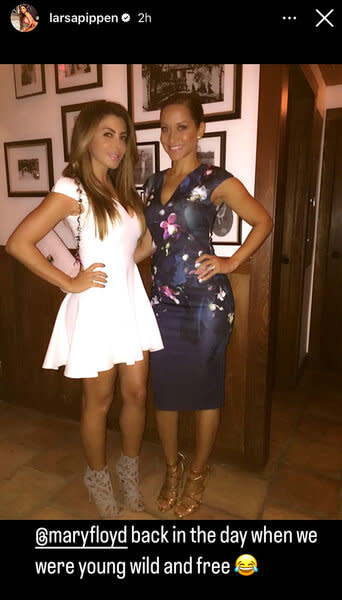 Larsa Pippen wearing a white dress and ankle booties standing with a friend.