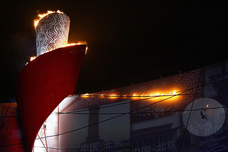 The Olympic Flame is lit by former Chinese gymnast Li Ning during the Opening Ceremony for the 2008 Beijing Summer Olympics at the National Stadium on Aug. 8, 2008 in Beijing, China.<span class="copyright">Jeff Gross—Getty Images</span>