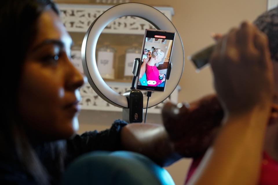 Vidhi Heiland, owner of Essential Henna, uses her phone to record videos of her henna crowns that she uploads to TikTok. Heiland went viral after sharing a story about creating the artwork for those suffering from hair loss due to cancer.