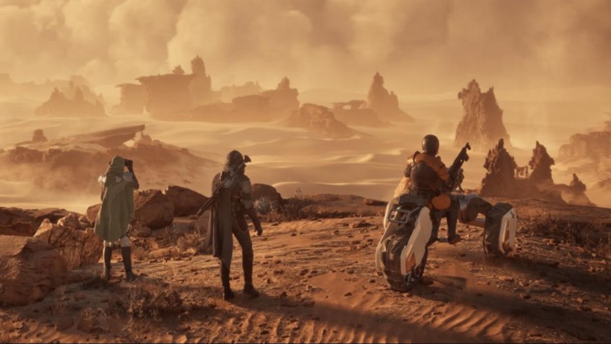  Three players look out over Arrakis. One is sat on a bike. 
