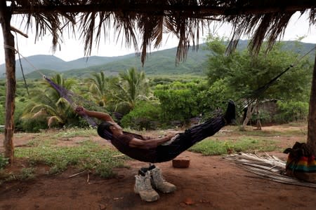 A member of the Community Police rests on a hammock at a checkpoint in the municipality of San Diego Xayakalan