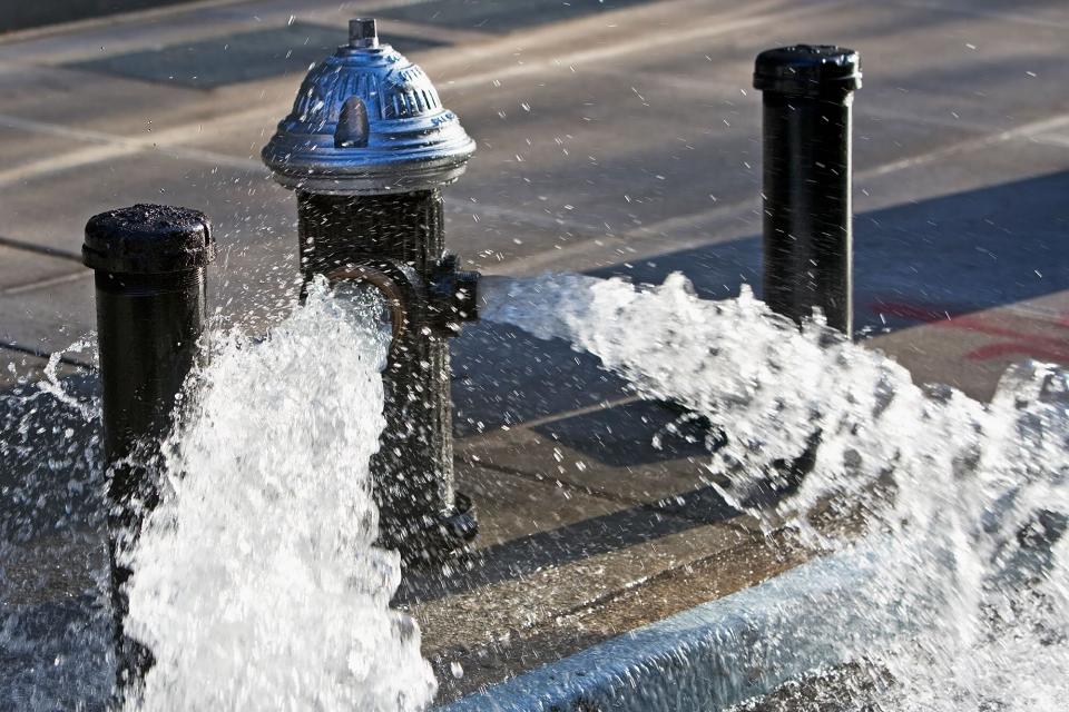 Fire hydrant open on city street