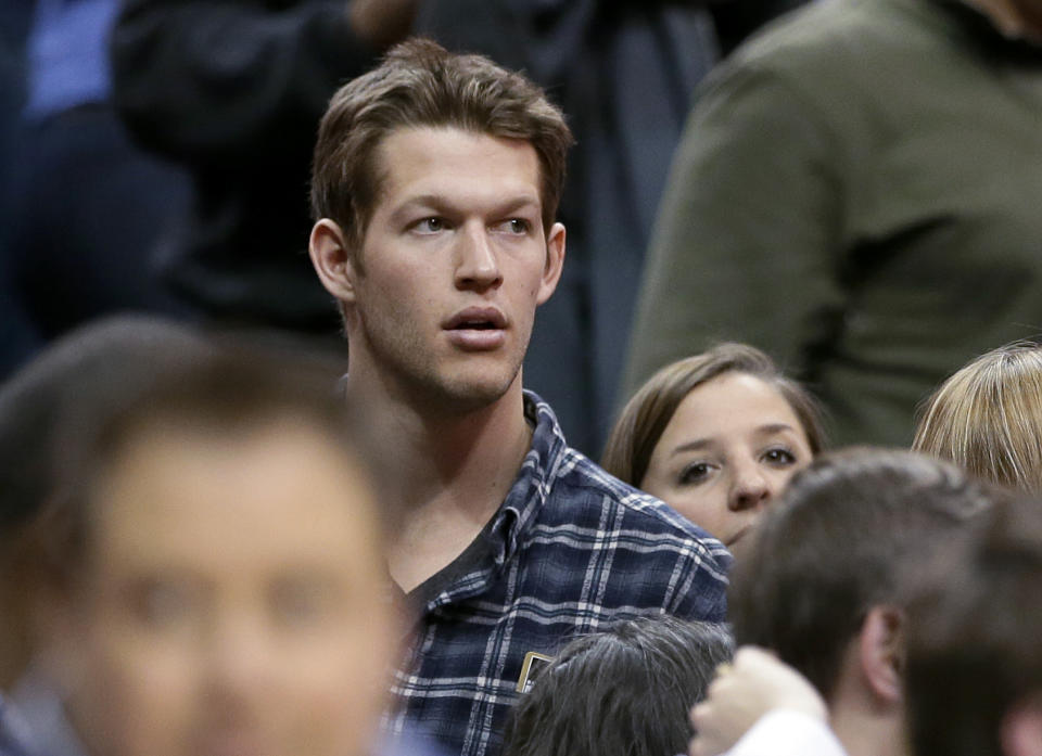 FILE - This Jan. 7, 2014 file photo shows Los Angeles Dodgers pitcher Clayton Kershaw at the end of an NBA basketball game between the Los Angeles Lakers and Dallas Mavericks in Dallas. A person familiar with the deal says Kershaw has agreed to a $215 million, seven-year contract with the Dodgers, a deal that makes the two-time Cy Young Award winner baseball's first player with a $30 million average salary. The person spoke on condition of anonymity Wednesday, Jan. 15, 2014 because the agreement had not yet been announced. (AP Photo/Tony Gutierrez, File)