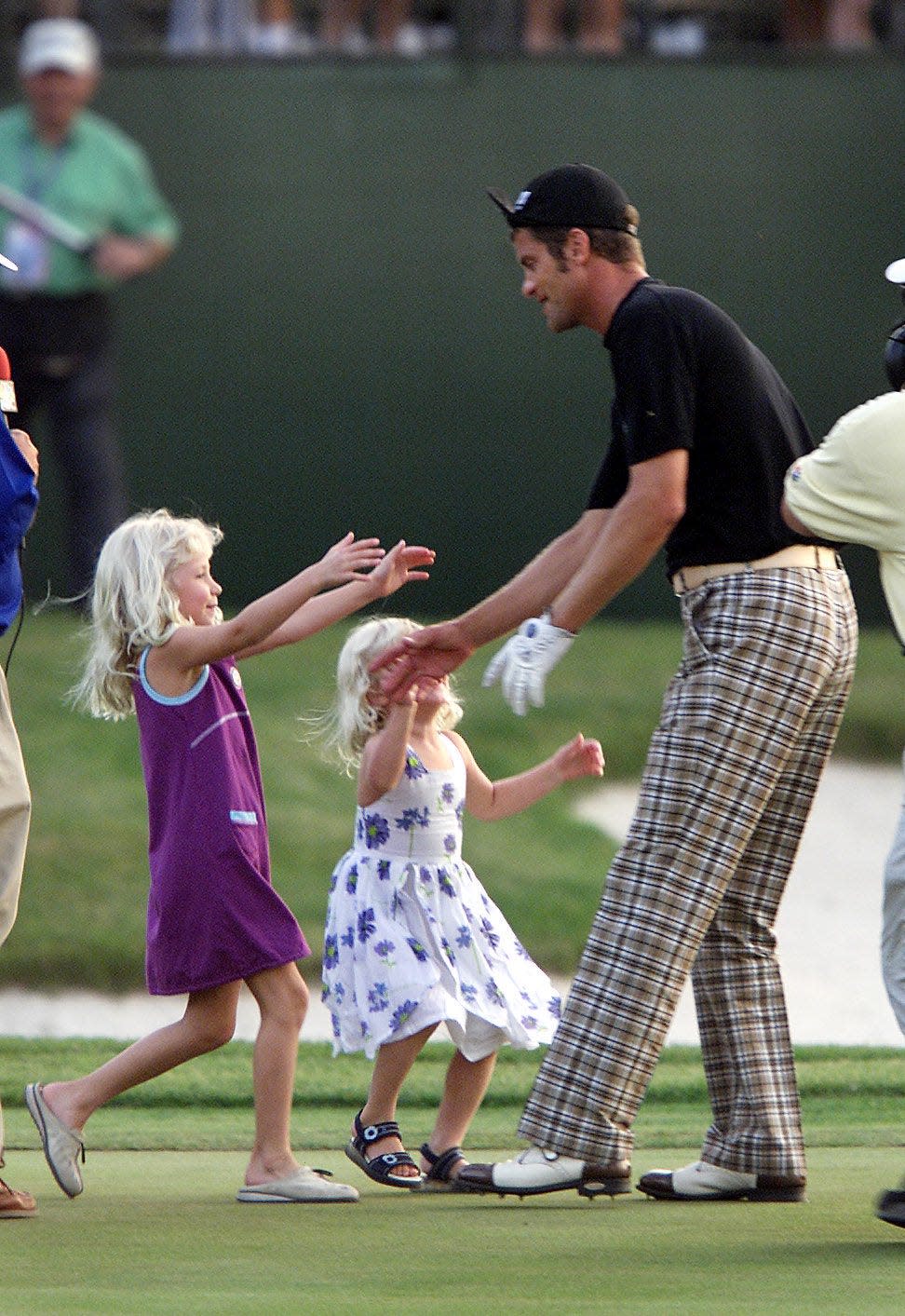 Jesper Parnevik is rushed by two of his daughters, 5-year-old Peg (left), and 3-year-old Penny, on the 18th green after winning the Honda Classic by a stroke on March 11, 2001 at the TPC at Heron Bay in Coral Springs. The Honda Classic eventually moved to PGA National in Palm Beach Gardens and is now called the Cognizant Classic.