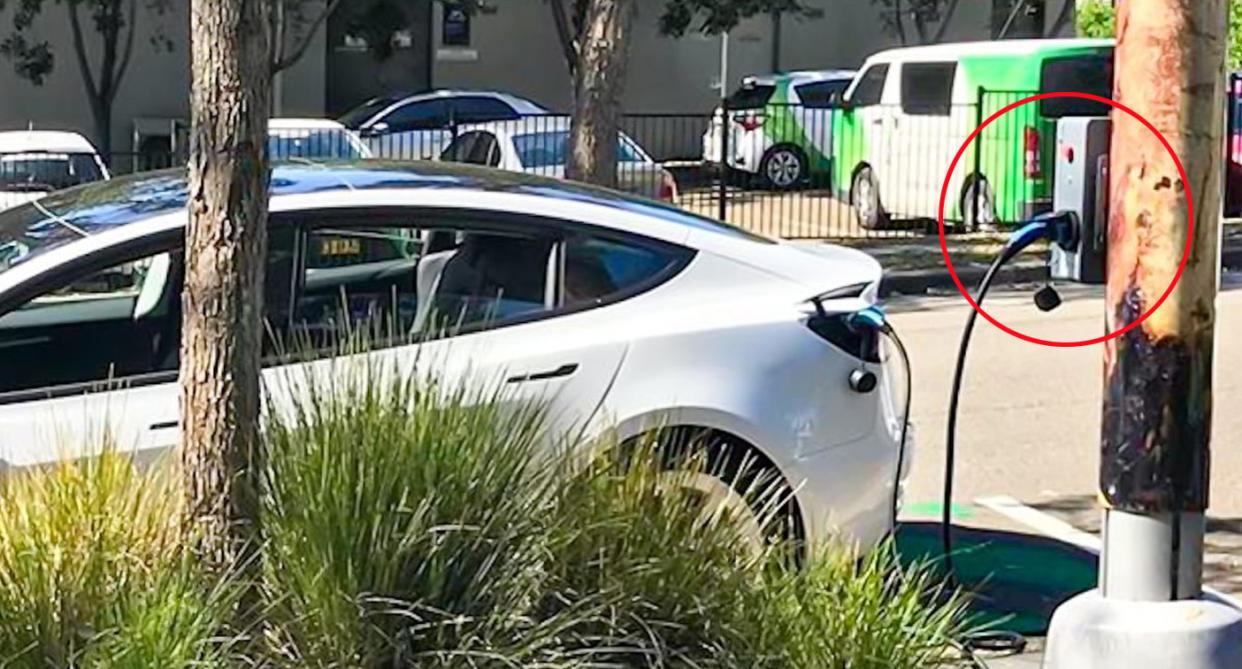 White Tesla charging with EV power pole charger in Sydney. 