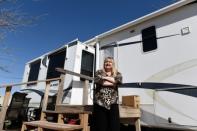 Dana Caldwell stands outside of the trailer that she bought to save money on housing in Midland