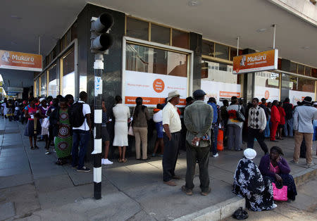Zimbabweans queue to withdraw cash, at money transfer agency in the capital Harare, July 7,2016. REUTERS/Philimon Bulawayo