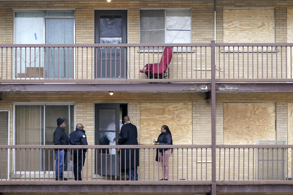 Harvey, Ill., Mayor Christopher J. Clark talks with a resident as he tours an apartment complex with other city officials Monday, Jan. 8, 2024, in Harvey, Ill. Clark, in a series of residential interviews reluctantly acknowledged that people were still inside their units when the boarding began. He said he wanted to hear from residents and not social media videos. (AP Photo/Charles Rex Arbogast)