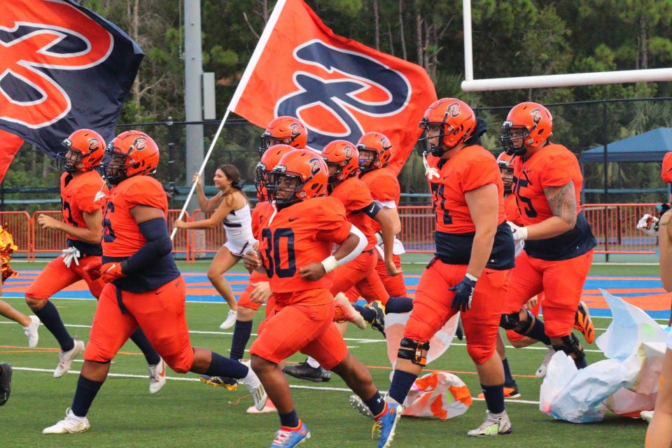 Benjamin football players run out onto the field ahead of a culture-shifting 27-21 home win over Clearwater International Academy on Friday, August 8, 2023.