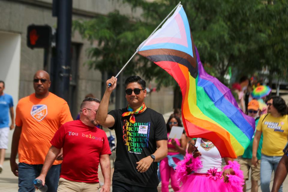 Cincinnati Mayor After Pureval waves the LGBTQ+ flag during the Cincinnati Pride Parade in 2022.