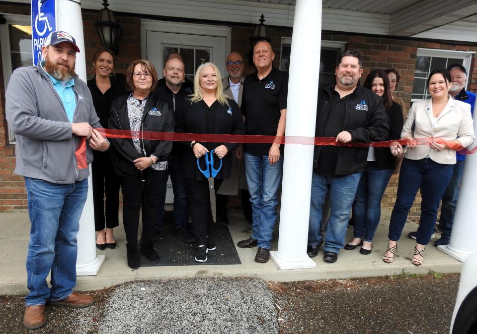 A ribbon cutting was held recently for Leonard and Newland Real Estate Services' new Coshocton office with local officials and personnel of the company.