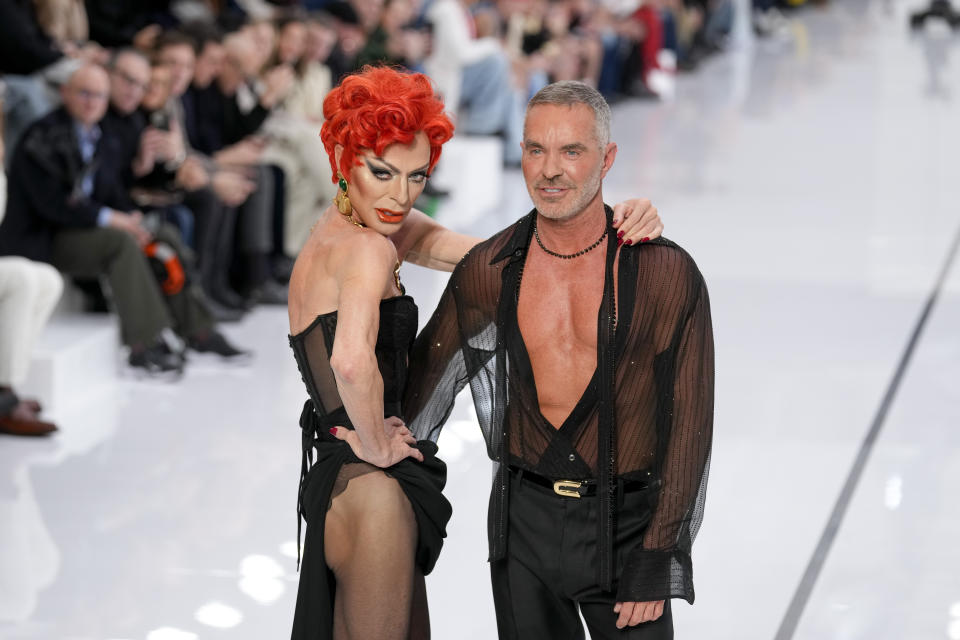 Designers Dean Caten, left, and Dan Caten accept applause after the men's Dsquared2 Fall-Winter 2024-2025 collection, that was presented in Milan, Italy, Friday, Jan. 12, 2024. (AP Photo/Antonio Calanni).