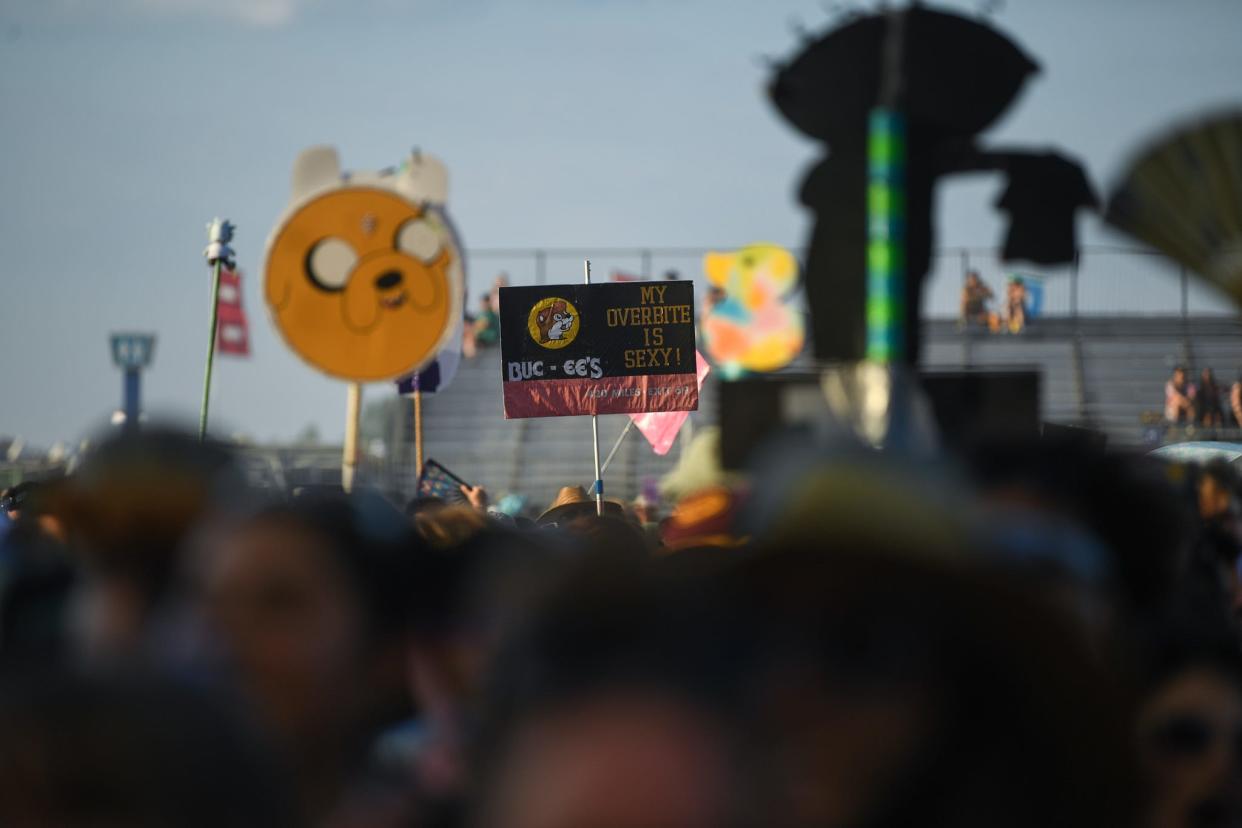 A Buc-ee's sign peaks out from the crowd during Dominic Fike's set at Bonnaroo in Manchester, Tenn., Friday, June 14, 2024.