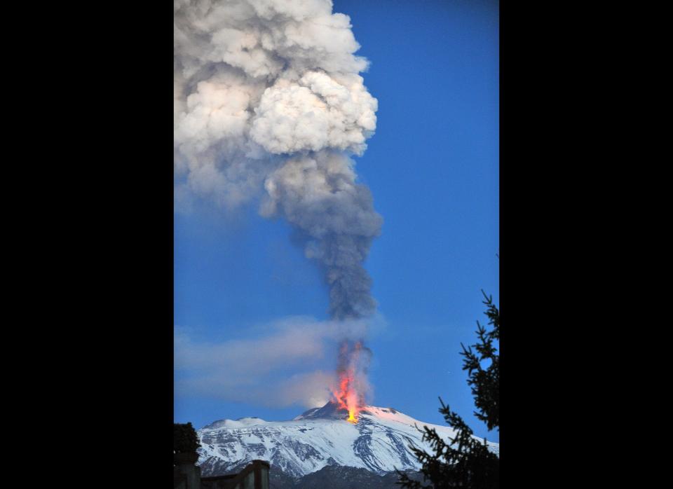 Lava spews as smoke billows from a crater of the giant Etna Volcano on the southern Italian island of Sicily on January 6, 2012. A column of hot ash spewed high into the sky from Italy's Mount Etna on the Mediterranean island of Sicily on January 5, as Europe's highest active volcano rumbled back to life. AFP PHOTO/ MARCELLO PATERNOSTRO (Photo credit should read MARCELLO PATERNOSTRO/AFP/Getty Images)