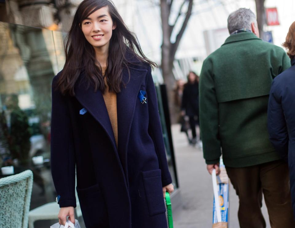 <p>Side-swept bangs add a touch of Parisian flair to this simple beauty look. Just throw on a menswear-inspired overcoat and you're good to go! (Photo: Getty Images) </p>