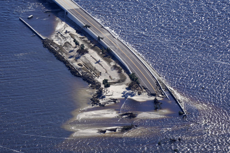 In this aerial photo made in a flight provided by mediccorps.org, damage from Hurricane Ian is seen on the causeway leading to Sanibel Island from Fort Myers, Fla., Friday, Sept. 30, 2022. (AP Photo/Gerald Herbert)