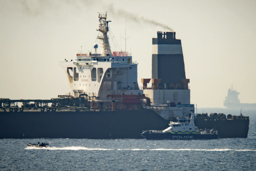 FILE - In this Thursday, July 4, 2019 file photo, a Royal Marine patrol vessel is seen beside the Grace 1 super tanker in the British territory of Gibraltar. Taken on its own, Iran’s seizure of a British-flagged oil tanker in the Strait of Hormuz may seem like a brazen act of aggression, a provocative poke in the nose to both Britain and its chief ally, the United States. But Iran seems to view the armed takeover of the Stena Impero as a carefully calibrated response to the July 4 taking of an Iranian supertanker off the coast of Gibraltar, an operation in which Britain’s Royal Marines played a major role. (AP Photo/Marcos Moreno, File)