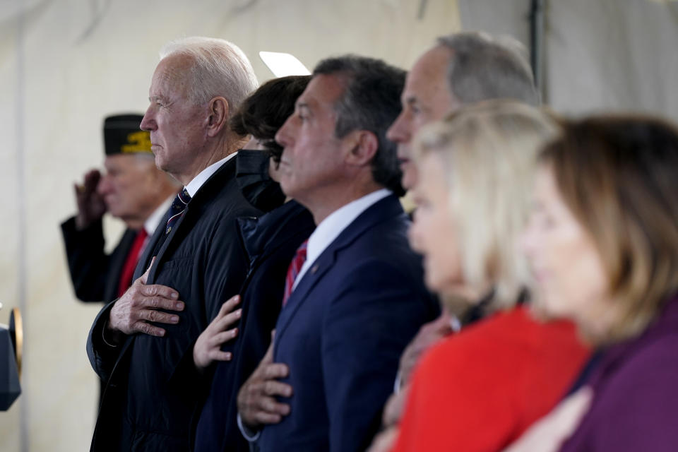 President Joe Biden stands as a rendition of the national anthem is performed during a Memorial Day event at Veterans Memorial Park at the Delaware Memorial Bridge in New Castle, Del., Sunday, May 30, 2021. (AP Photo/Patrick Semansky)