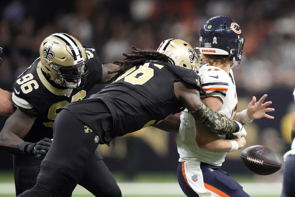 Chicago Bears quarterback Tyson Bagent, right, fumbles as he is sacked by New Orleans Saints linebacker Demario Davis (56) during the second half of an NFL football game in New Orleans, Sunday, Nov. 5, 2023. (AP Photo/Gerald Herbert)