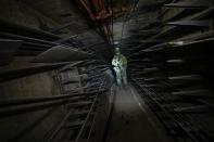 A Russian soldier inspects a labyrinth of the Metallurgical Combine Azovstal where Ukrainian troops were based in Mariupol, in a territory which is under the control of the Government of the Donetsk People's Republic, eastern Ukraine, Monday, June 13, 2022. This photo was taken during a trip organized by the Russian Ministry of Defense. (AP Photo)