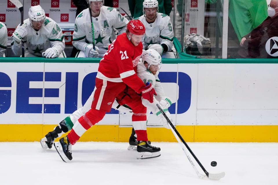 Detroit Red Wings defenseman Dennis Cholowski (21) and Dallas Stars center Joe Pavelski (16) compete for control of the puck in the first period at American Airlines Center in Dallas on Tuesday, April 20, 2021.