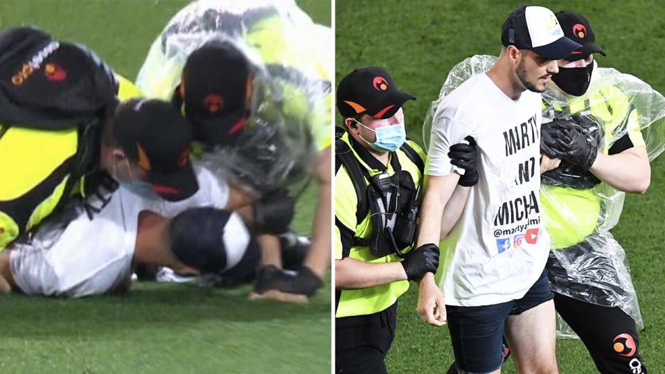 The two men, pictured here after running onto the field during the AFL grand final.