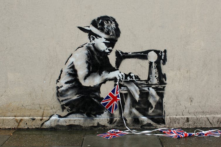 <span class="caption">Banksy’s Slave Labour mural on Turnpike Lane in north London.</span> <span class="attribution"><span class="source">DeptfordJon via Flickr</span>, <a class="link " href="http://creativecommons.org/licenses/by-sa/4.0/" rel="nofollow noopener" target="_blank" data-ylk="slk:CC BY-SA;elm:context_link;itc:0;sec:content-canvas">CC BY-SA</a></span>
