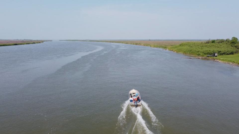 Barry Carriere sails his boat down the Saskatchewan River Delta near the community of Cumberland House. The delta is home to many species of fish, insects, moose, bears and migratory birds.