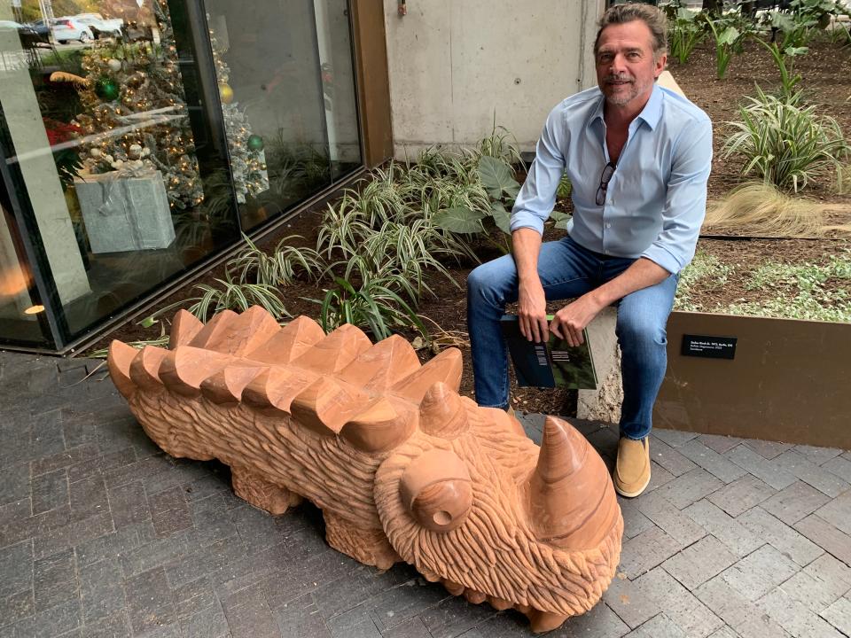 Stephen King is an art-loving former real estate investment banker who owns a group of hotels that includes the Loren Hotel at Lady Bird Lake in Austin. In the hotel courtyard, he sits behind Stefan Rinck's sandstone sculpture "Buffalo Stegosaurus."
