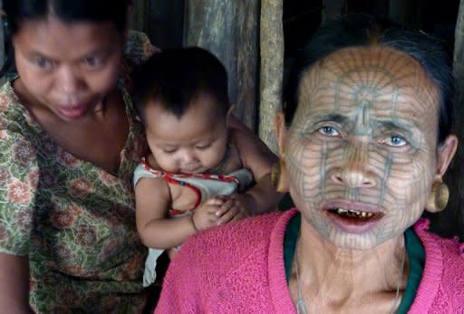 An ethnic minority Chin woman, bearing a facial tattoo, is pictured in Panmaung Village, in Myanmar's remote northwest. The ritual was officially banned by the then socialist regime in the 1960s, and the tattoos became increasingly rare as Christian missionaries converted the previously animist communities, according to a local pastor