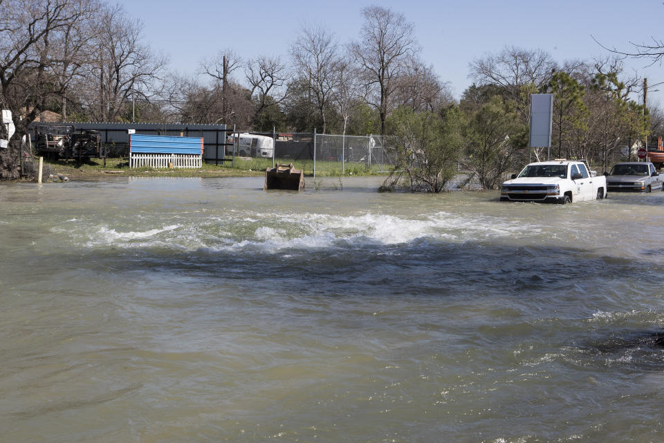 Water surges up from under the street from a water main break that flooded Clinton Drive just east of the East Loop 610 on Thursday, Feb. 27, 2020 in Houston. The flooding closed the major freeway that circles the city. ( Brett Coomer/Houston Chronicle via AP)