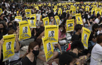 Pro-democracy students hold posters of a missing Thai activist during a protest at the Thammasat University in Pathum Thani, north of Bangkok, Thailand, Monday, Aug, 10, 2020. Protesters last week warned that they'll step up pressure on the government if it failed to meet their demands, which include dissolving the parliament, holding new elections and changing the constitution. (AP Photo/Sakchai Lalit)