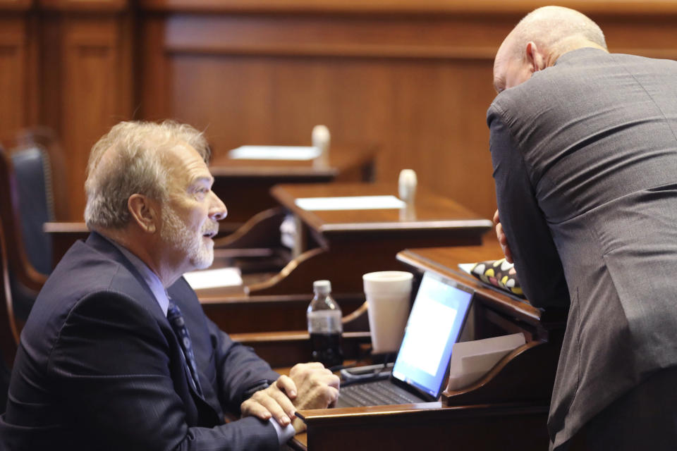 Democratic South Carolina Senate Minority Leader Brad Hutto, left, speaks to Senate Clerk Jeffrey Gossett before a debate on a bill banning abortion on Wednesday, Sept. 7, 2022, in Columbia, S.C. (AP Photo/Jeffrey Collins)