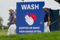 Justin Thomas, of the United States, left, and Tiger Woods, of the United States, wait to putt on the 17th green during the first round of the US Open Golf Championship, Thursday, Sept. 17, 2020, in Mamaroneck, N.Y. (AP Photo/Charles Krupa)